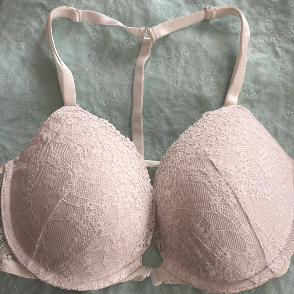 White Victoria secret bra with a T shape back with some lift padding .